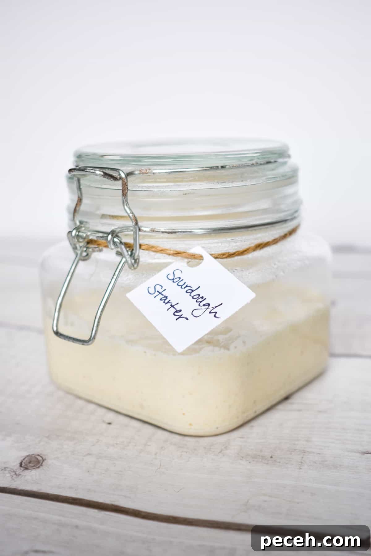 How to Make and Maintain a Sourdough Starter at Home 8 jar of sourdough starter with tag on it.