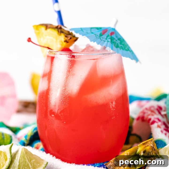 Classic Piña Colada Recipe: How to Make the Tropical Cocktail at Home 6 Close up view of an umbrella in a beach drink.