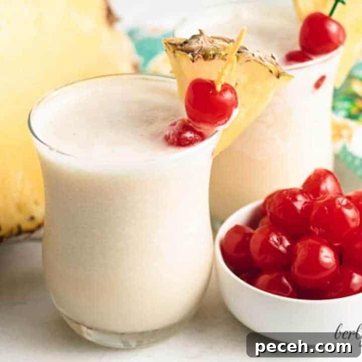 Classic Piña Colada Recipe: How to Make the Tropical Cocktail at Home 7 Two henny colada cocktails in small glasses.