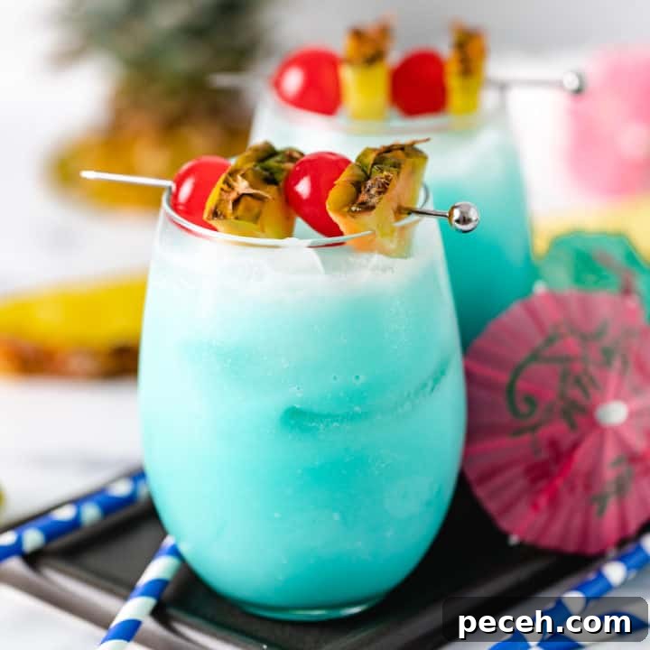 Classic Piña Colada Recipe: How to Make the Tropical Cocktail at Home 8 Close up view of two Blue Hawaiian Drinks.