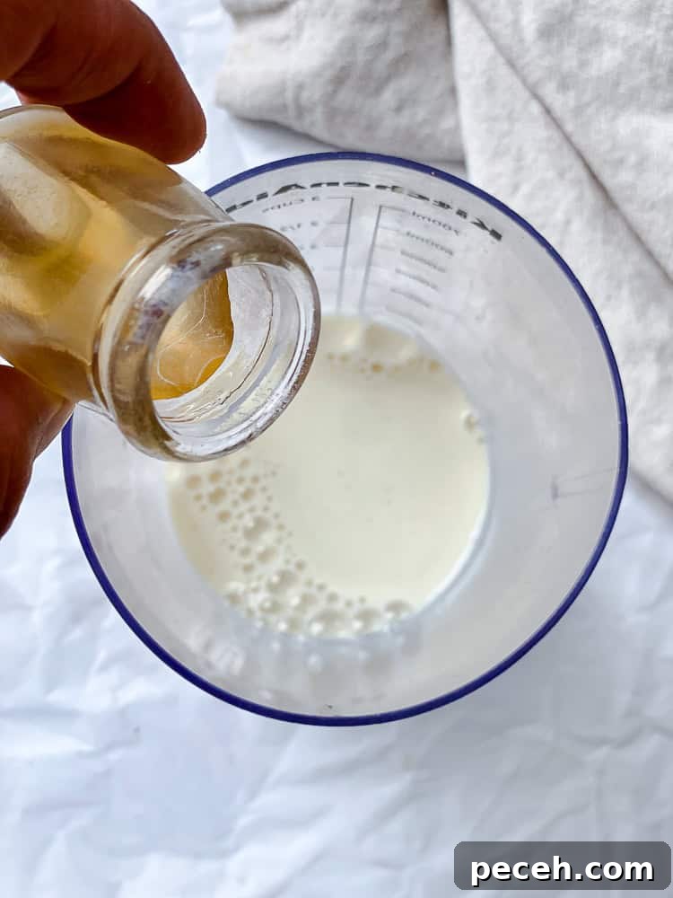 process shot of adding apple cider vinegar to plant milk
