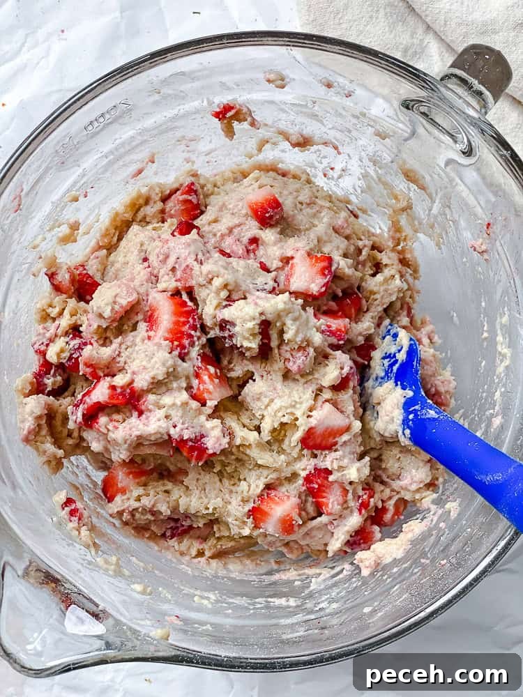 process shot showing strawberries folded into batter