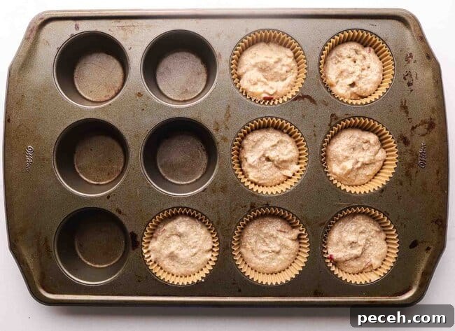 Unbaked muffins in a muffin tin.