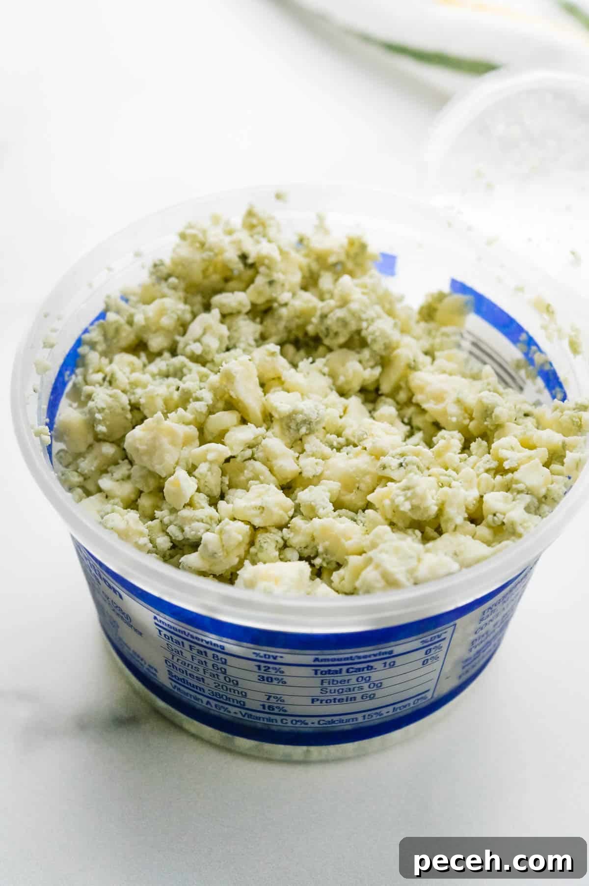 Creamy Chunky Blue Cheese Dressing Recipe 2 A container of blue cheese crumbles.