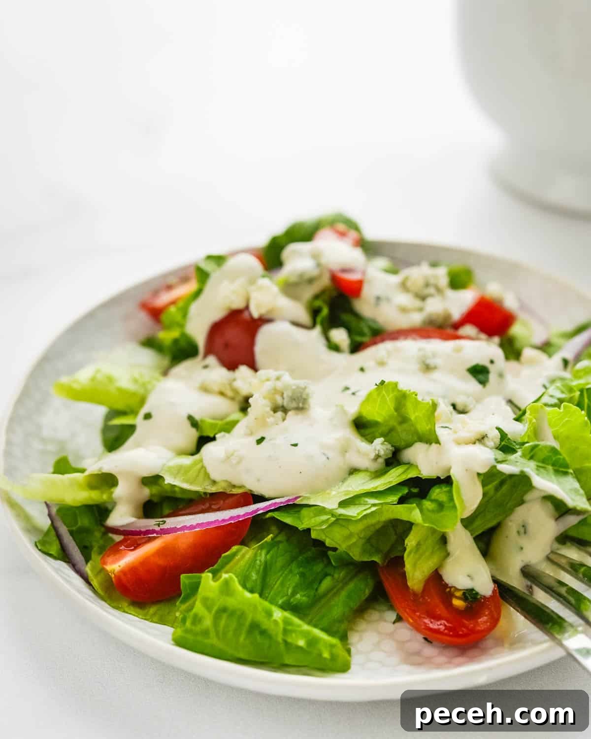 Creamy Chunky Blue Cheese Dressing Recipe 8 A green salad with blue cheese dressing.
