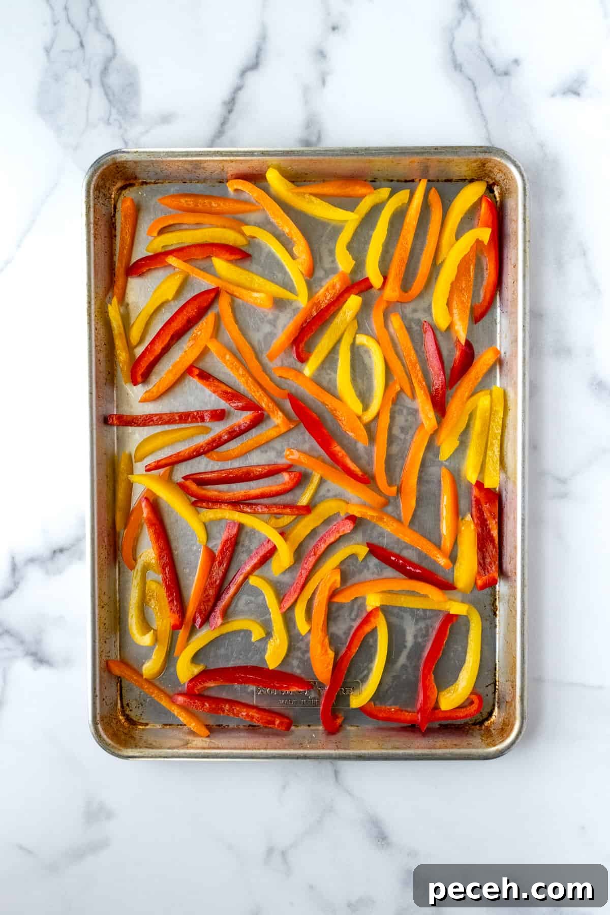 Bell pepper slices on a baking sheet.