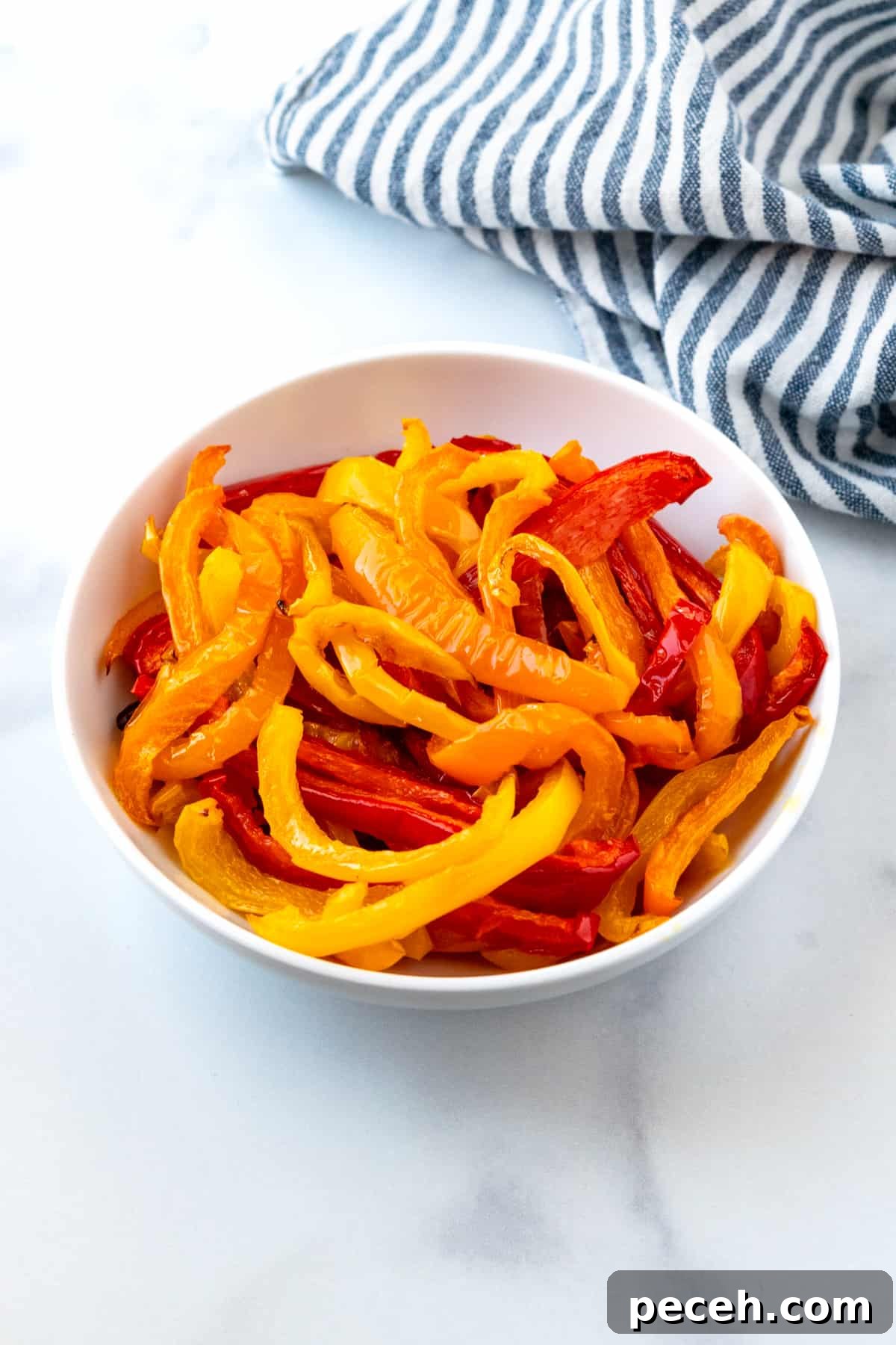 Oven roasted peppers in a white bowl.