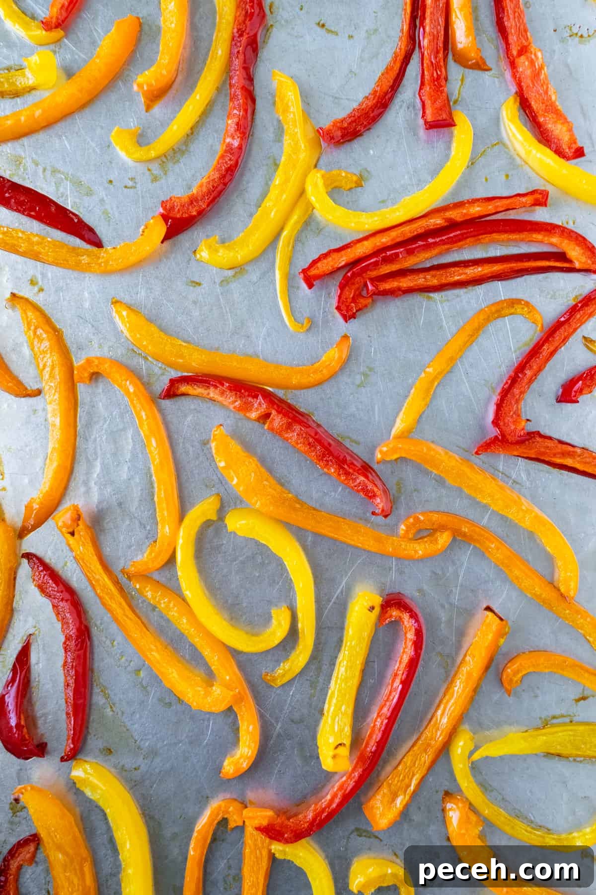 Roasted pepper slices on a baking sheet.