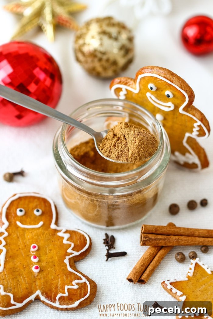 Homemade Gingerbread Spice Mix Picture Jar of gingerbread spice mix with gingerbread cookies, cinnamon sticks and festive ornaments.