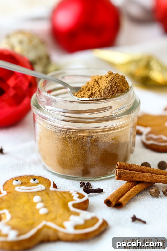 Homemade Gingerbread Spice Mix Jar Picture Open glass jar of Christmas gingerbread spice with a teaspoon resting inside.