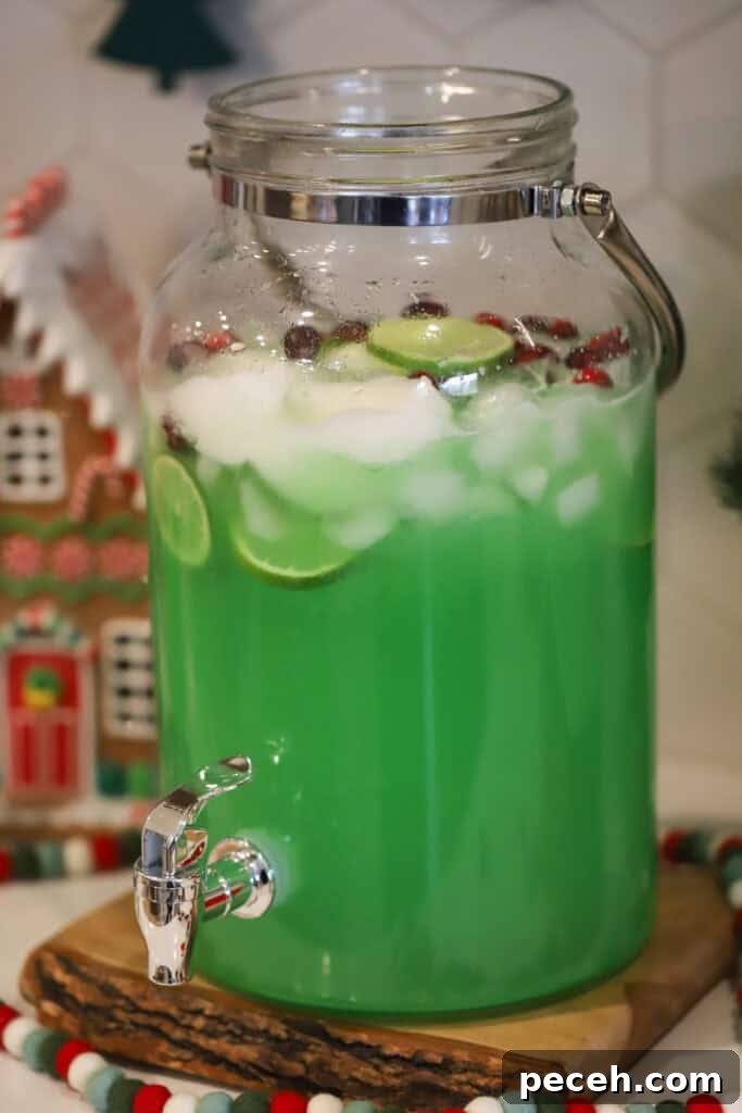 Grinch Punch Recipe: Festive Green Holiday Cocktail 2 A large punch jar filled with green grinch punch.