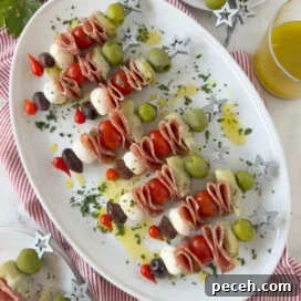 A platter of antipasto skewers with olives, cheese, salami, and artichoke heart for appetizers.