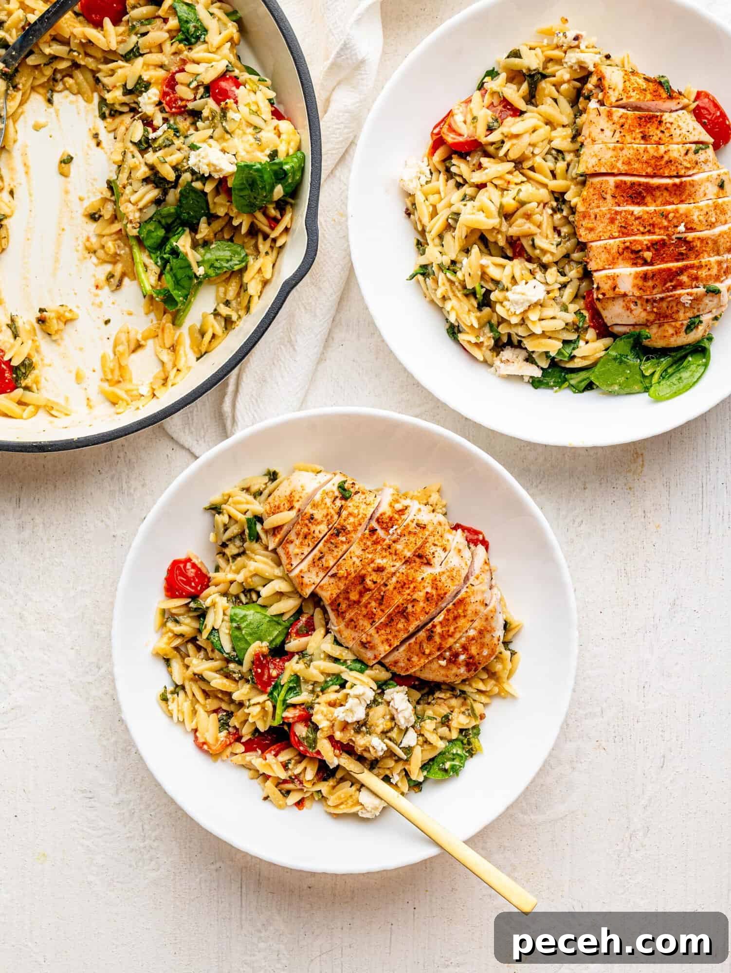 Spinach, Feta & Chicken Orzo Bake — Cheesy One-Pan Dinner 3 Bird's eye view of two white bowls with chicken and orzo bake.