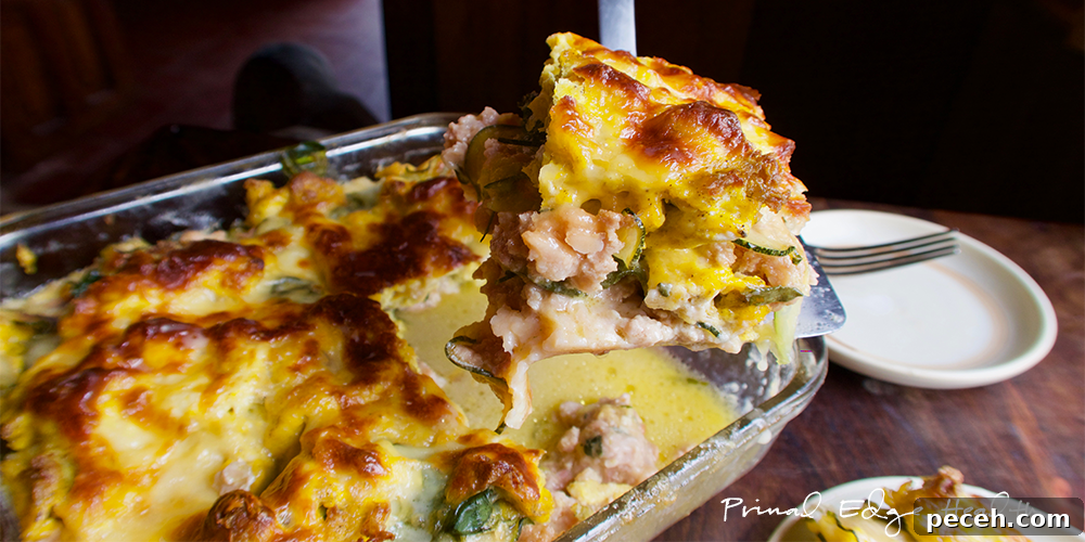 Breakfast lasagna being served at table.