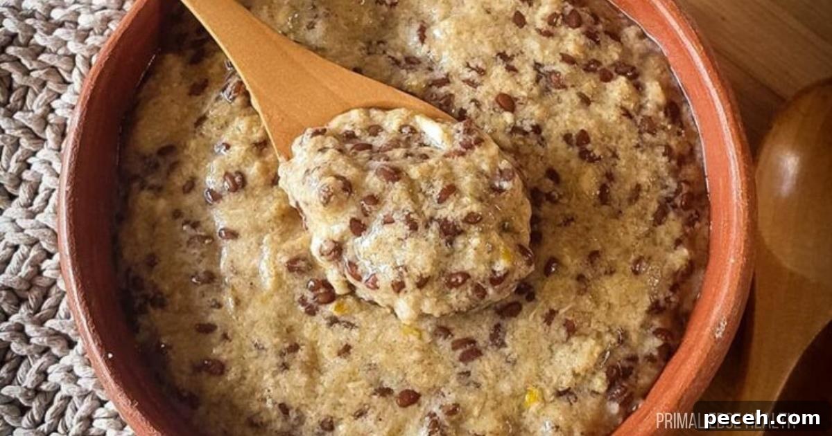 Hot cereal in a bowl with a wooden spoon.