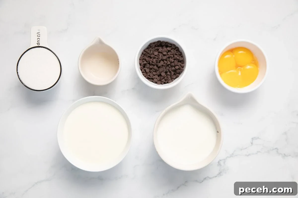 Ingredients set out on a counter. Heavy cream, egg yolks, chocolate chips, milk, sugar, vanilla and peppermint extract.