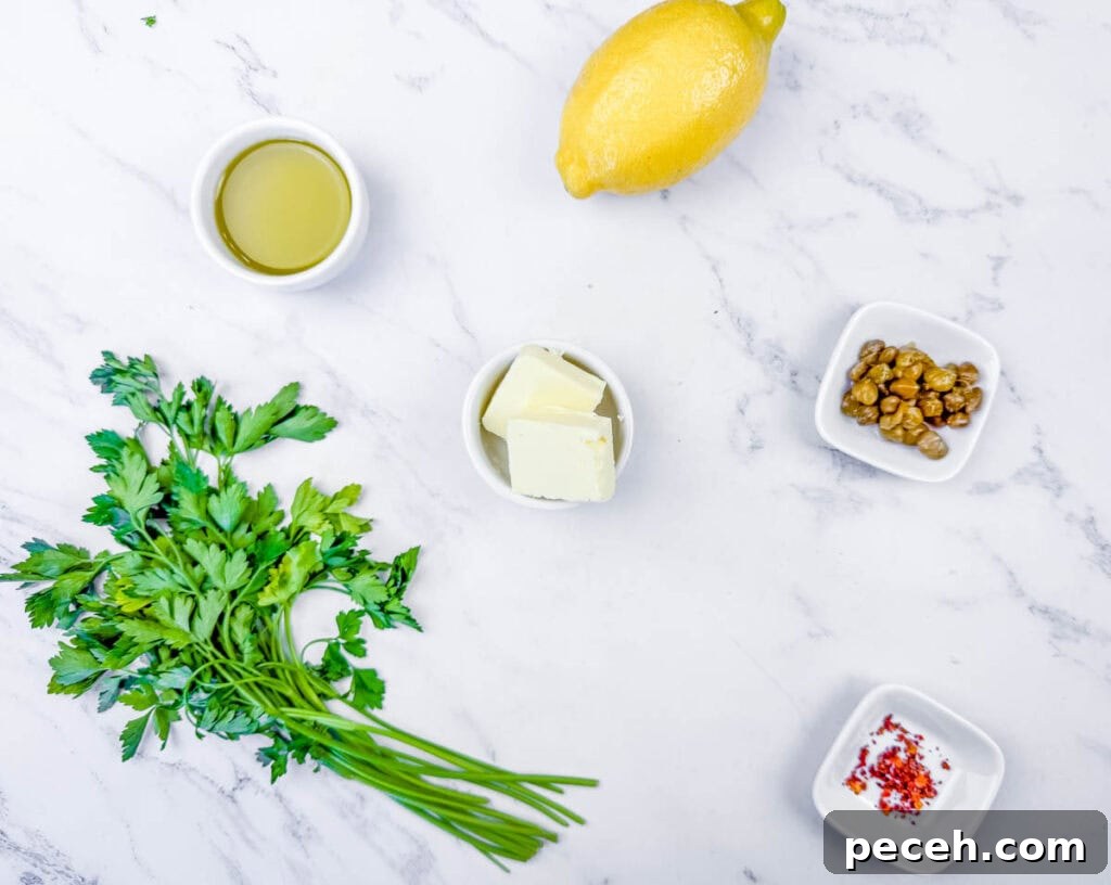 Crispy Pan-Fried Salmon Balls with Tangy Dill Sauce 11 Overhead shot of ingredients for a lemon-caper sauce: lemon, olive oil, butter, capers, red pepper flakes, and parsley.