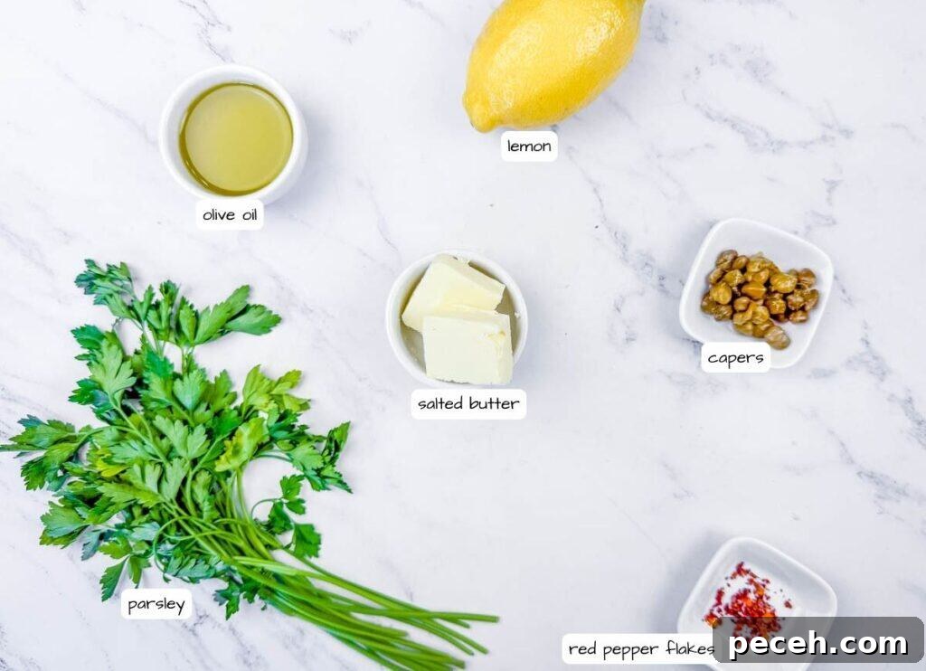 Crispy Pan-Fried Salmon Balls with Tangy Dill Sauce 5 Overhead shot of labeled ingredients for lemon butter sauce: lemon, olive oil, salted butter, capers, red pepper flakes, and flat-leaf parsley.