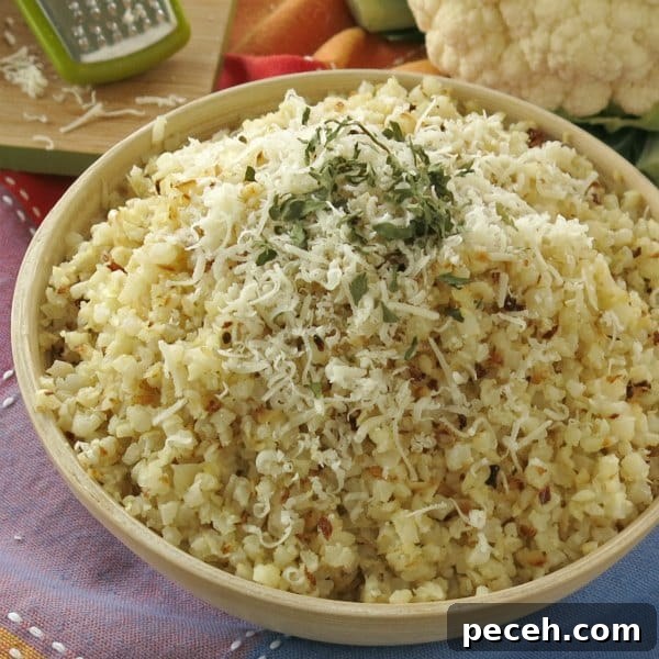 Bowl full of roasted cauliflower rice topped with parmesan cheese and parsley
