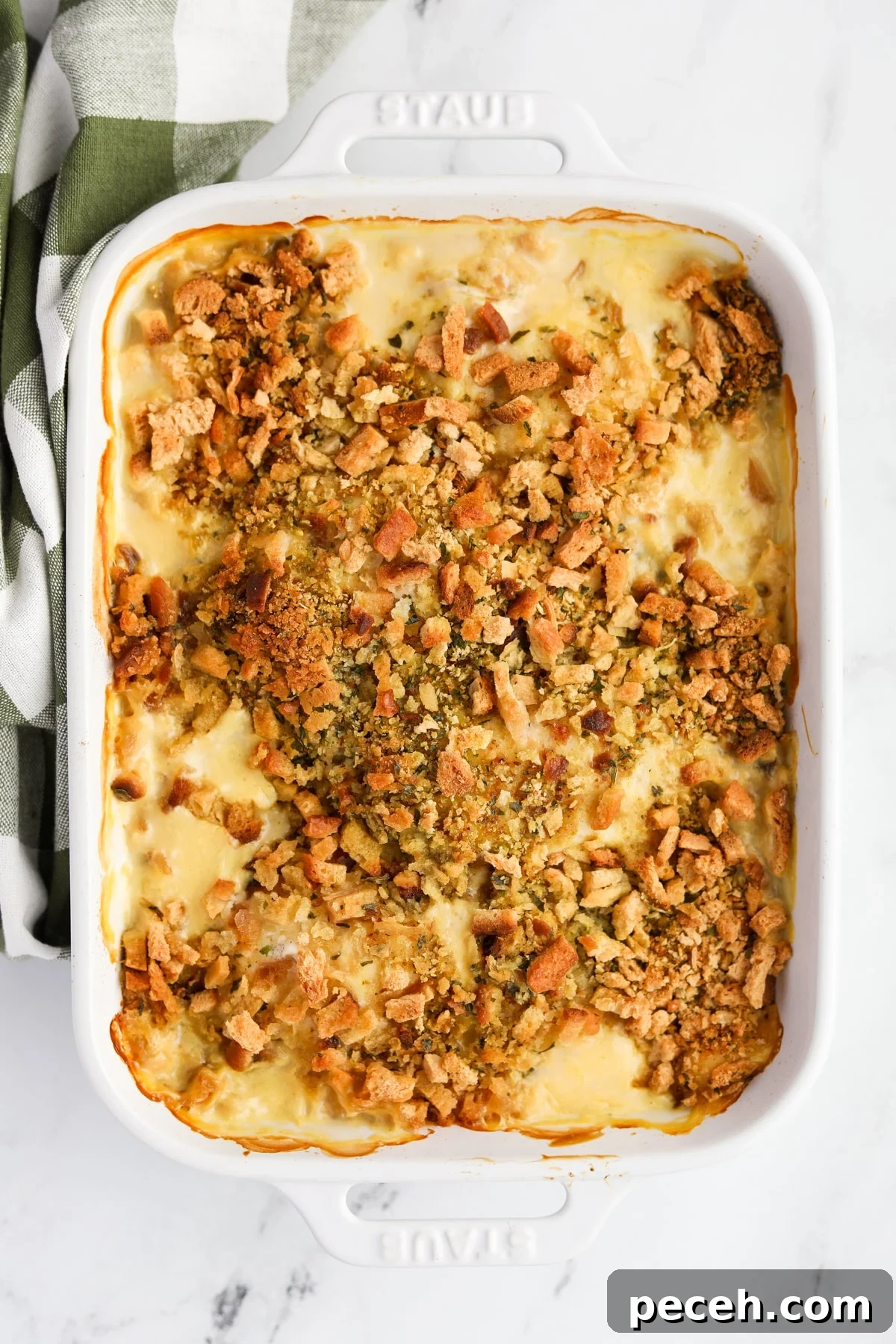 Creamy Swiss-Style Chicken Casserole with Mushrooms and Cheese 12 A baking dish filled with chicken and stuffing casserole.