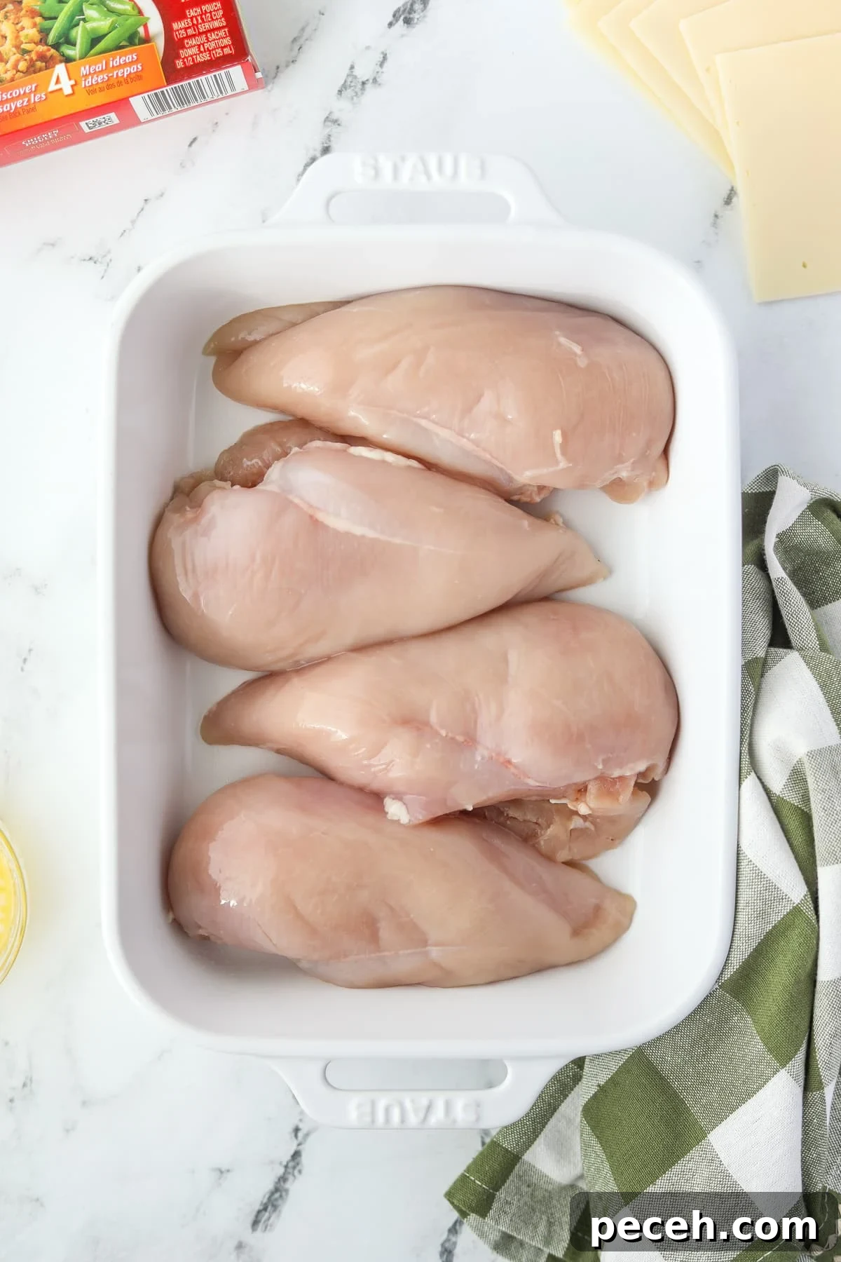 Creamy Swiss-Style Chicken Casserole with Mushrooms and Cheese 6 A baking dish with 4 chicken breasts in it.