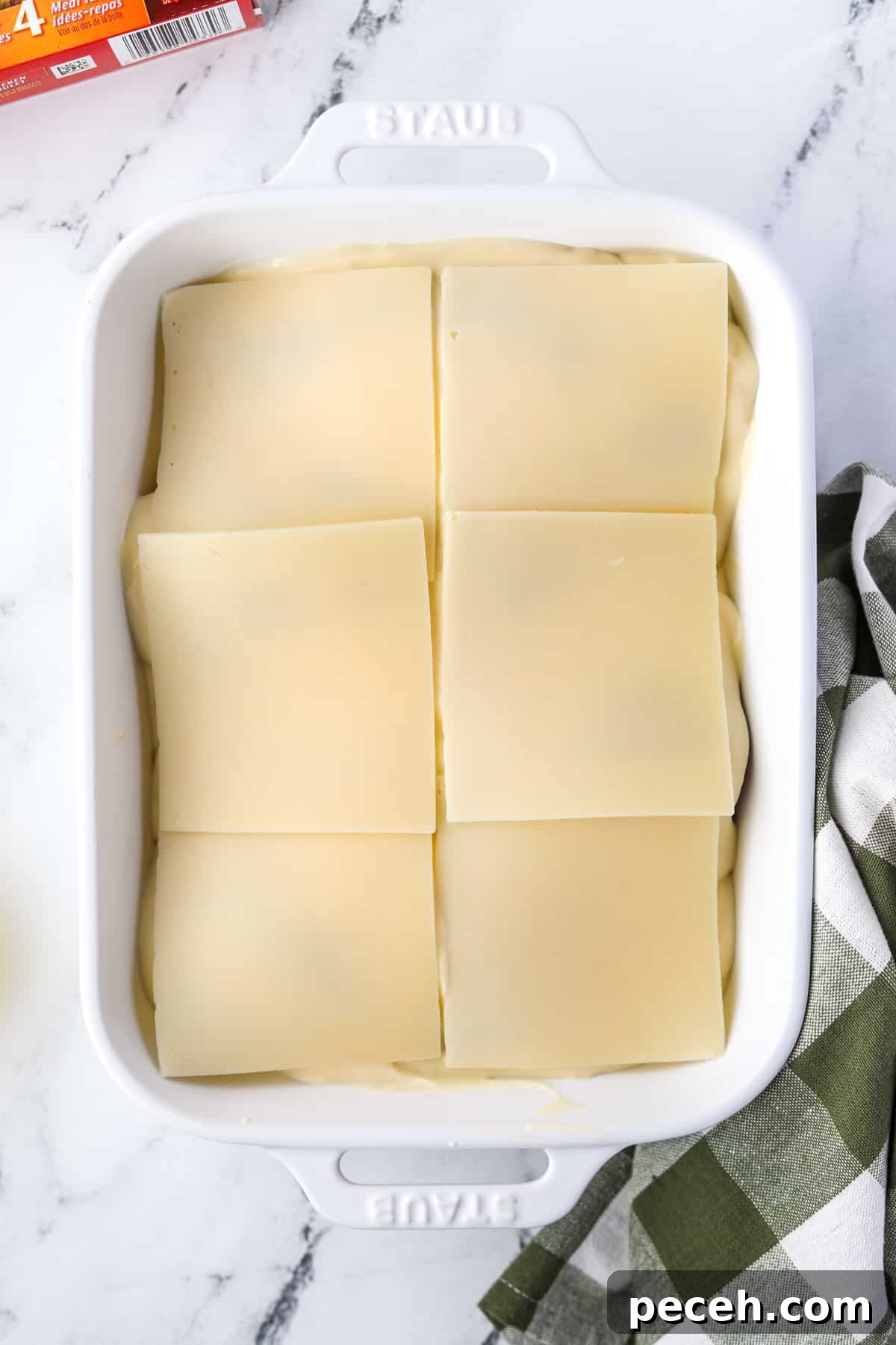 Creamy Swiss-Style Chicken Casserole with Mushrooms and Cheese 8 Topping a casserole with Swiss cheese slices.