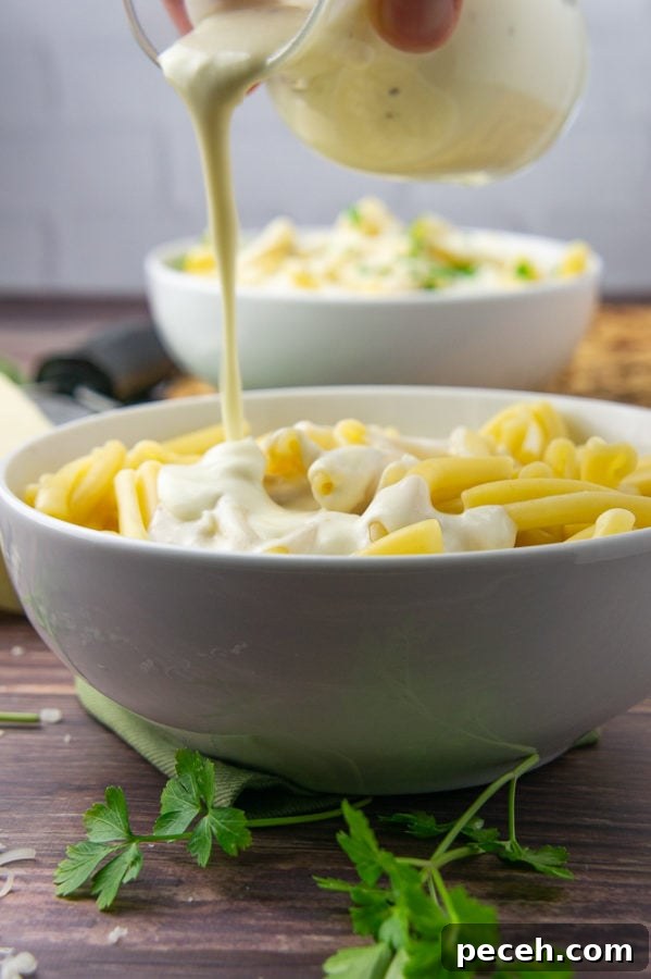Creamy Asiago Sauce Recipe for Pasta and Vegetables 5 a bowl of pasta with asiago sauce being poured over top