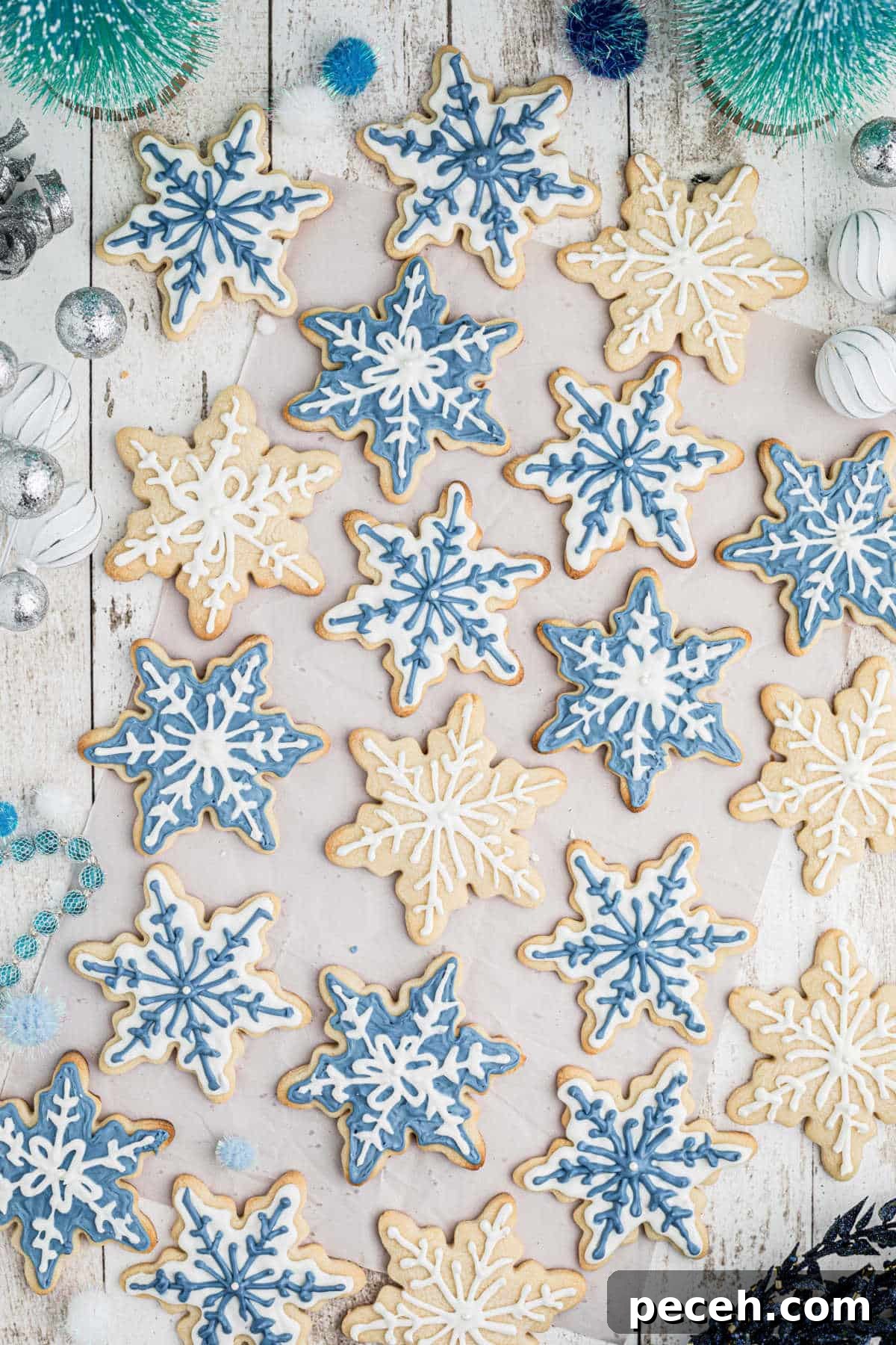 Snowflake Sugar Cookies: Festive Icing & Decorating Guide 2 Overhead shot of a lot of snowflake cookies in white and blue.