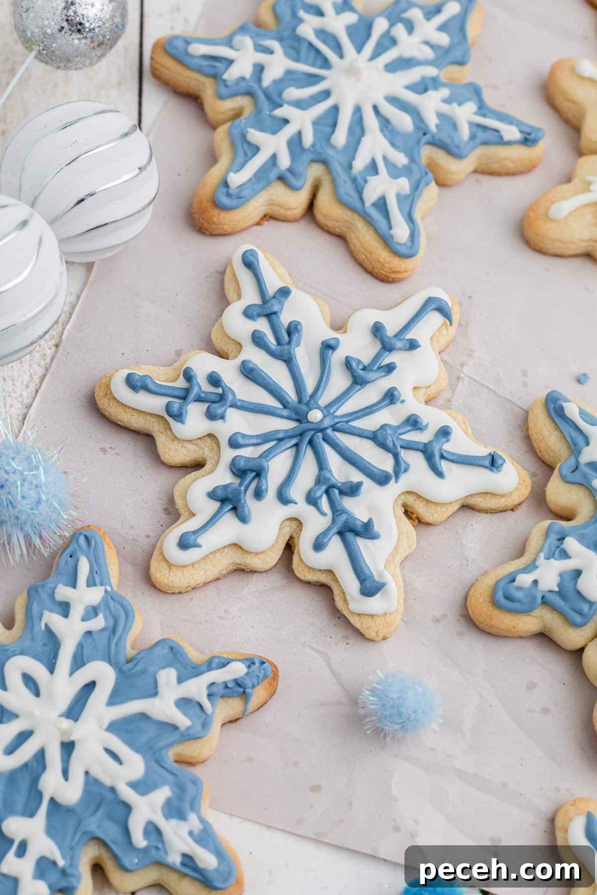 Snowflake Sugar Cookies: Festive Icing & Decorating Guide 4 White and blue snowflake cookies.