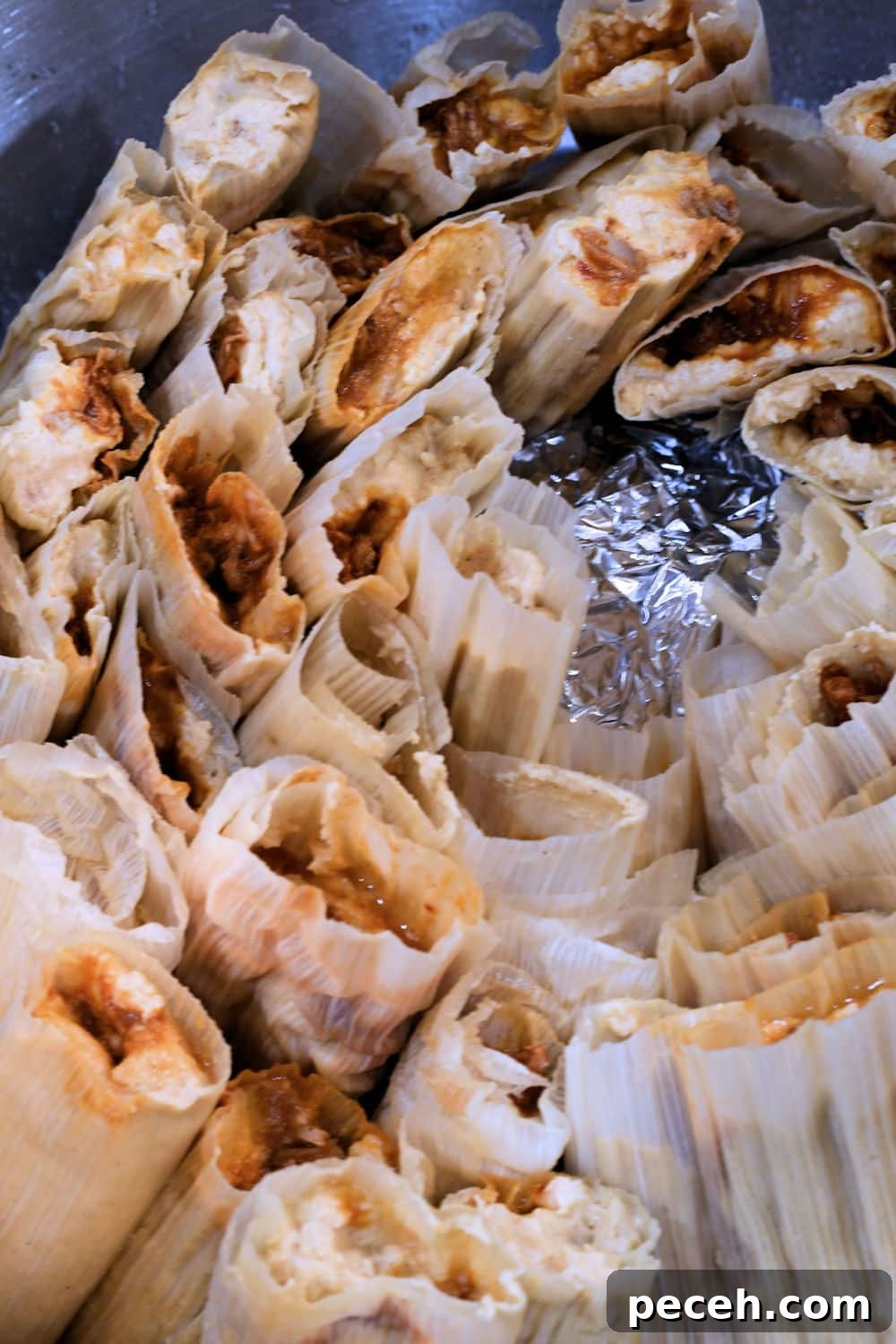 Tamales stacked in a tamale steamer, just before steaming.