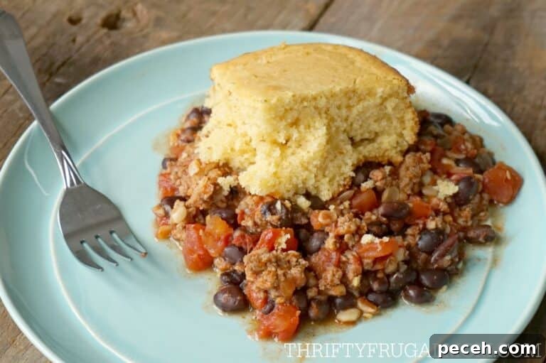 tamale pie made in a crockpot, served on an aqua plate