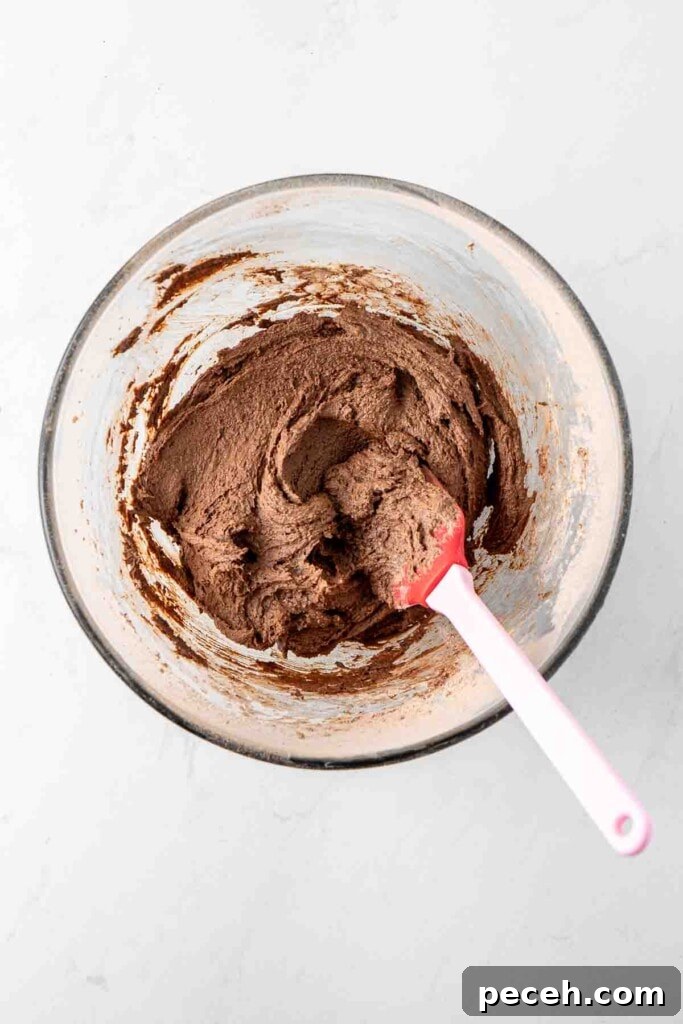 Fudgy Chocolate Crinkle Cookies Recipe 7 Mixing together the cookie dough in a glass bowl.