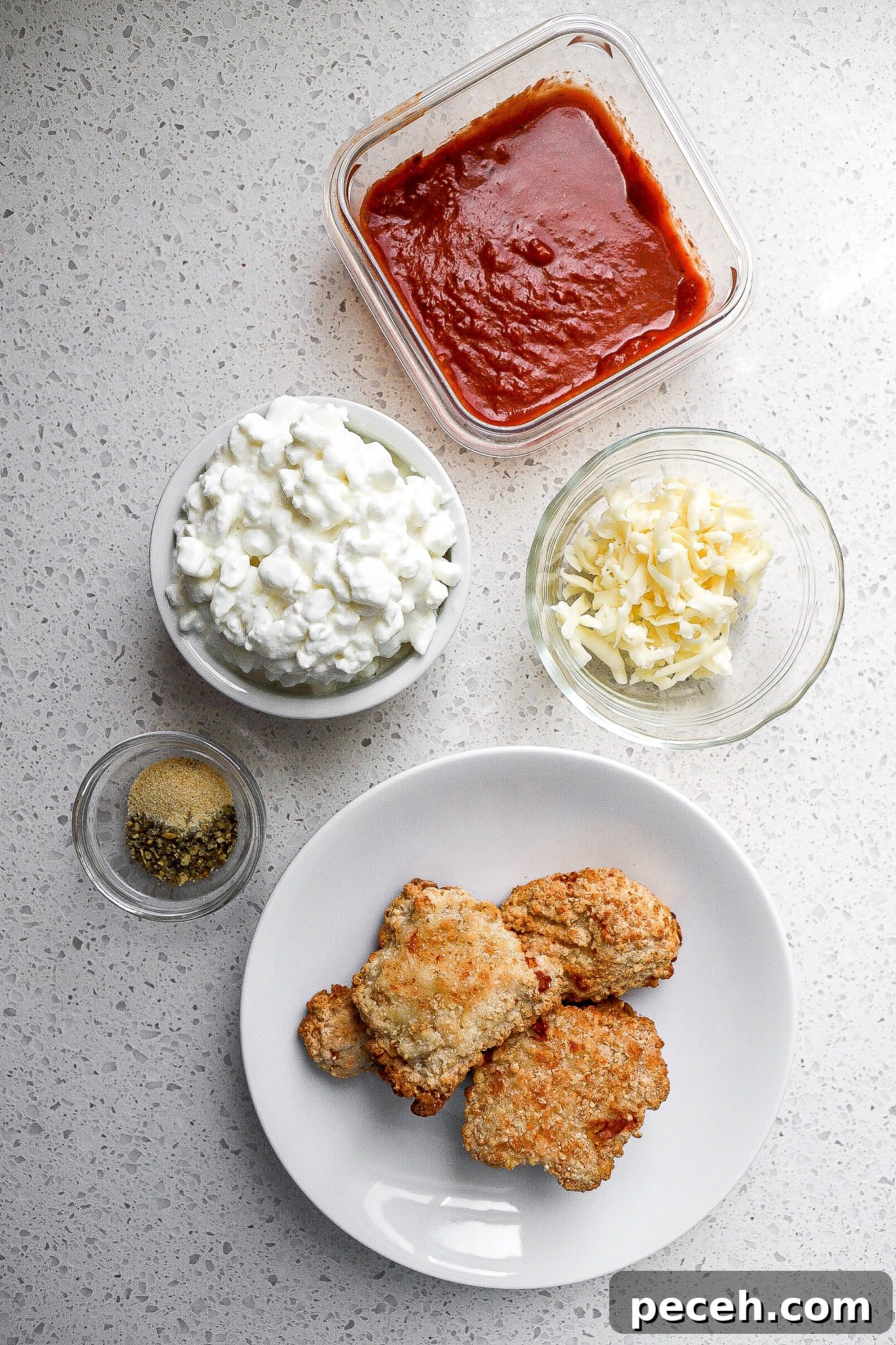 Chicken Parmesan Bowl with Cottage Cheese 4 Top down view of marinara, mozzarella cheese, and breaded chicken nuggets.