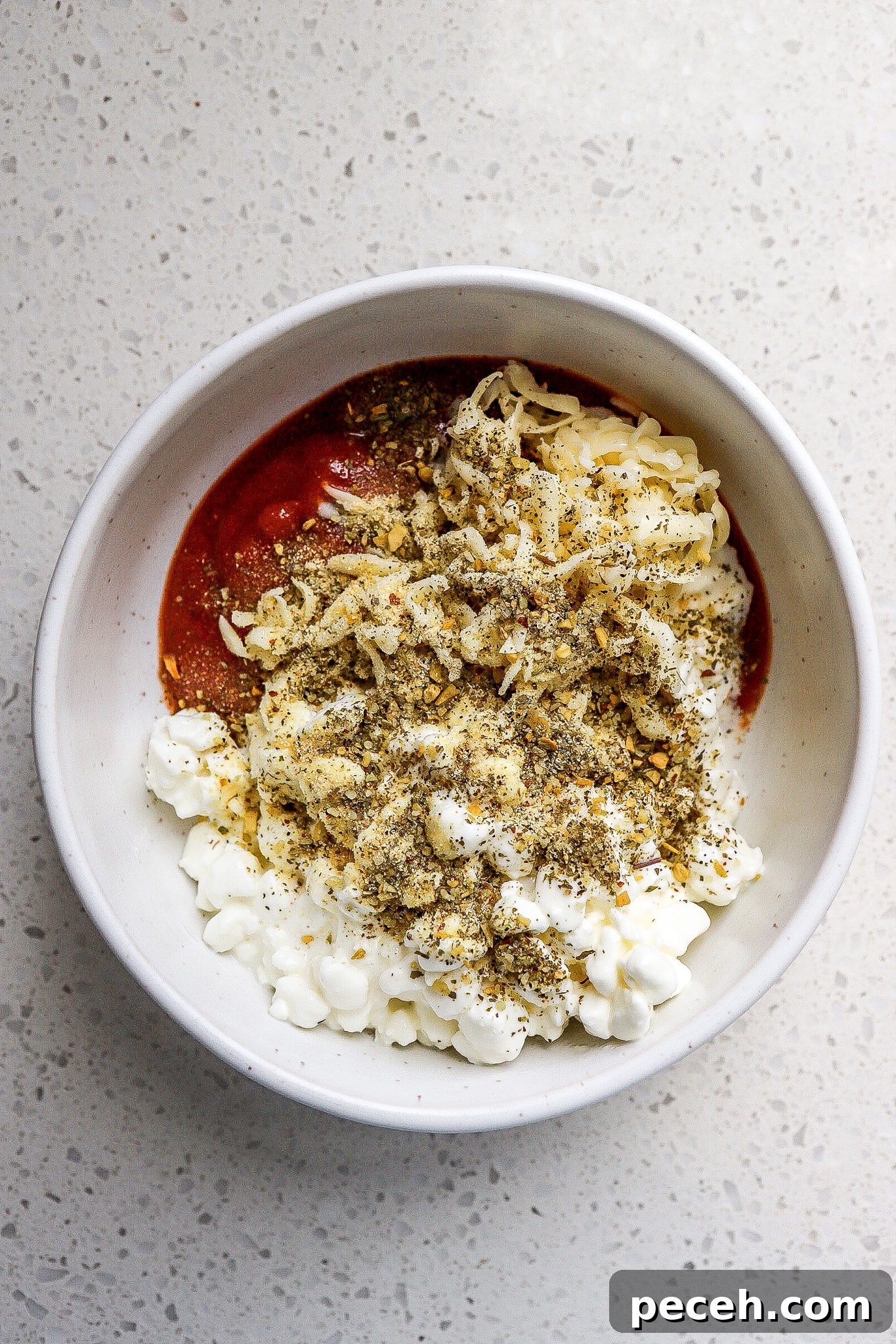 Chicken Parmesan Bowl with Cottage Cheese 5 Top down view of mozzarella cheese and marinara sauce.
