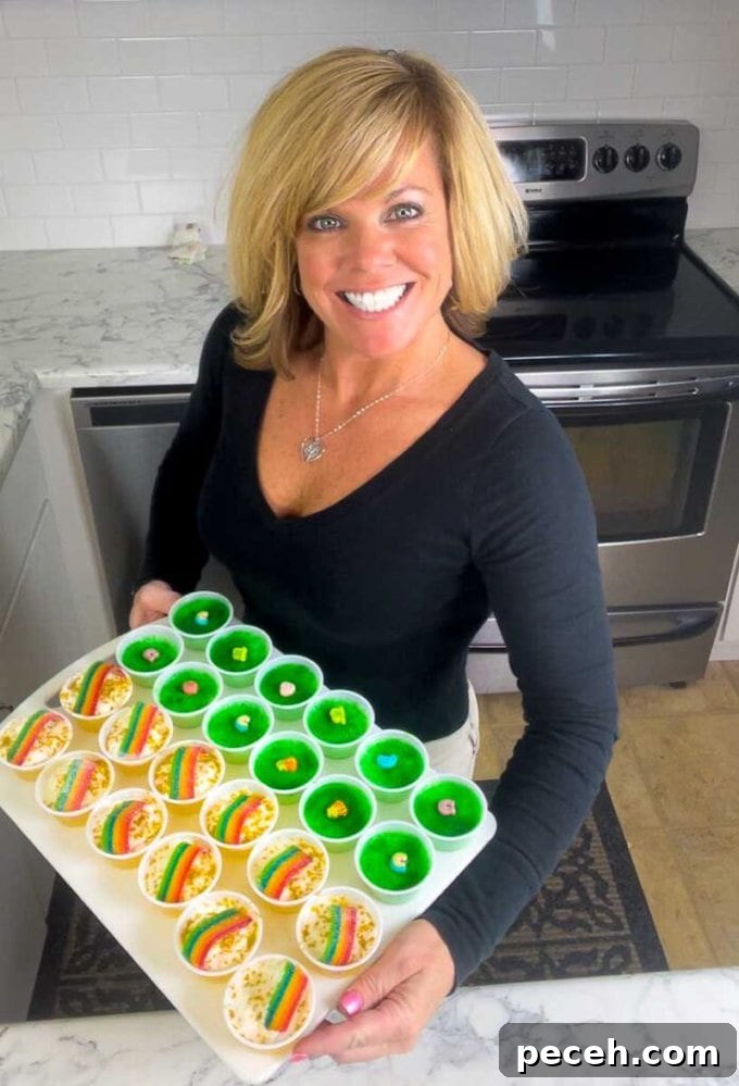 Pot of Gold Jello Shots for St. Patrick's Day 3 Jennifer holding a tray of pot o' gold and key lime lucky charms jello shots