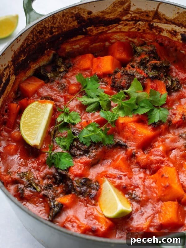 Creamy Sweet Potato Satay Curry with Coconut & Lime 12 sweet potato and chickpea curry served in a large green pot.