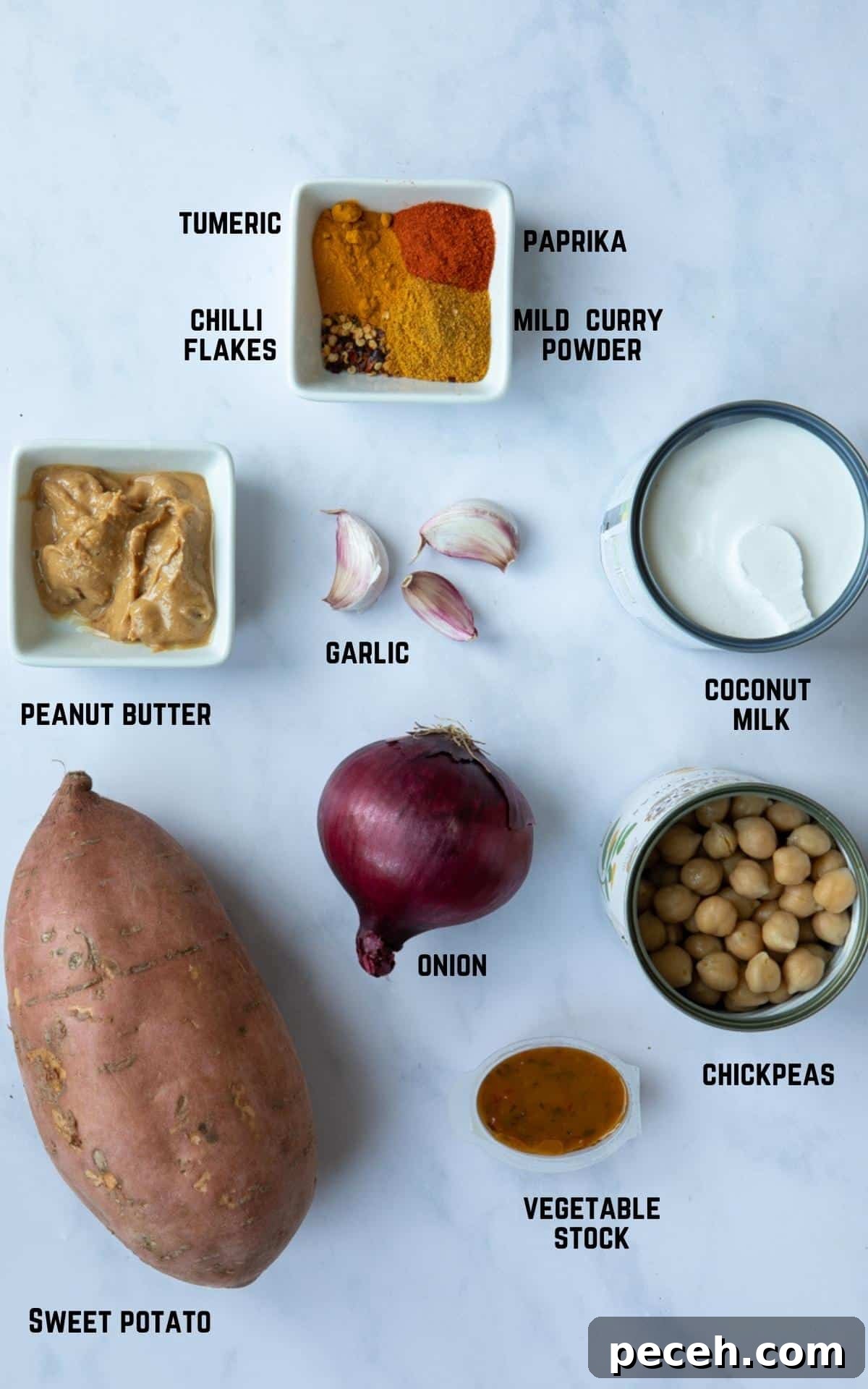Creamy Sweet Potato Satay Curry with Coconut & Lime 3 Ingredients to make Sweet Potato Satay Curry laid out on a white marble background.