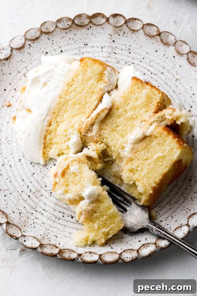 Light and Fluffy Banana Pudding Cake Recipe 12 slice of banana pudding cake on a plate with a bit taken out
