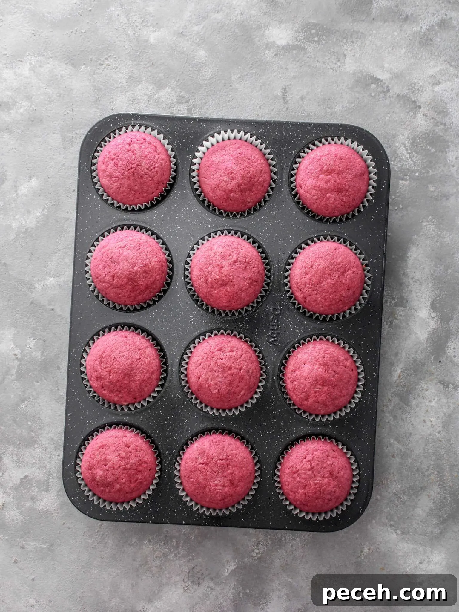 Fluffy Strawberry Cupcakes with Fresh Strawberry Frosting 8 baked strawberry cupcakes in cupcake tin
