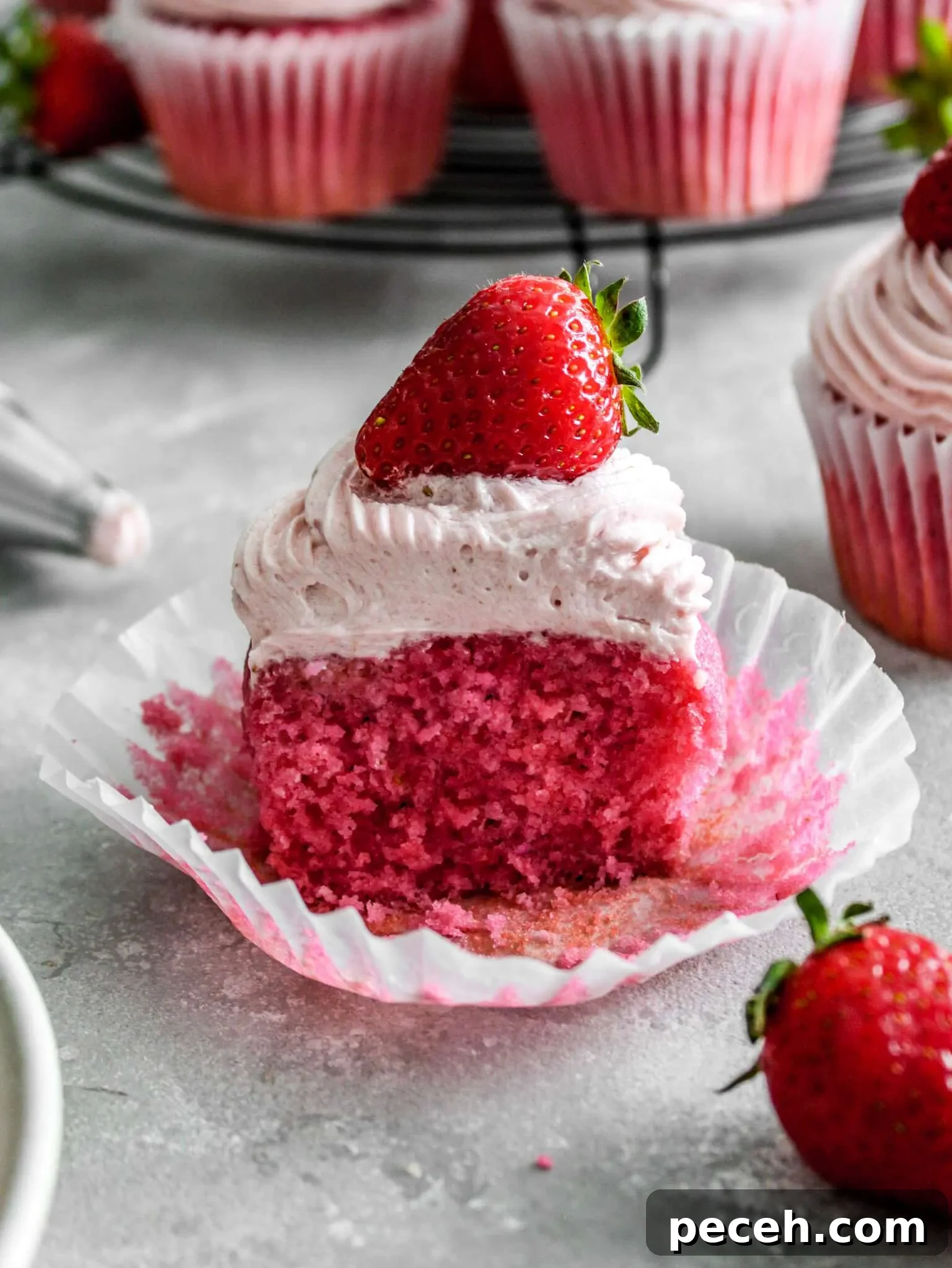Fluffy Strawberry Cupcakes with Fresh Strawberry Frosting 11 frosted strawberry cupcake on table (2)