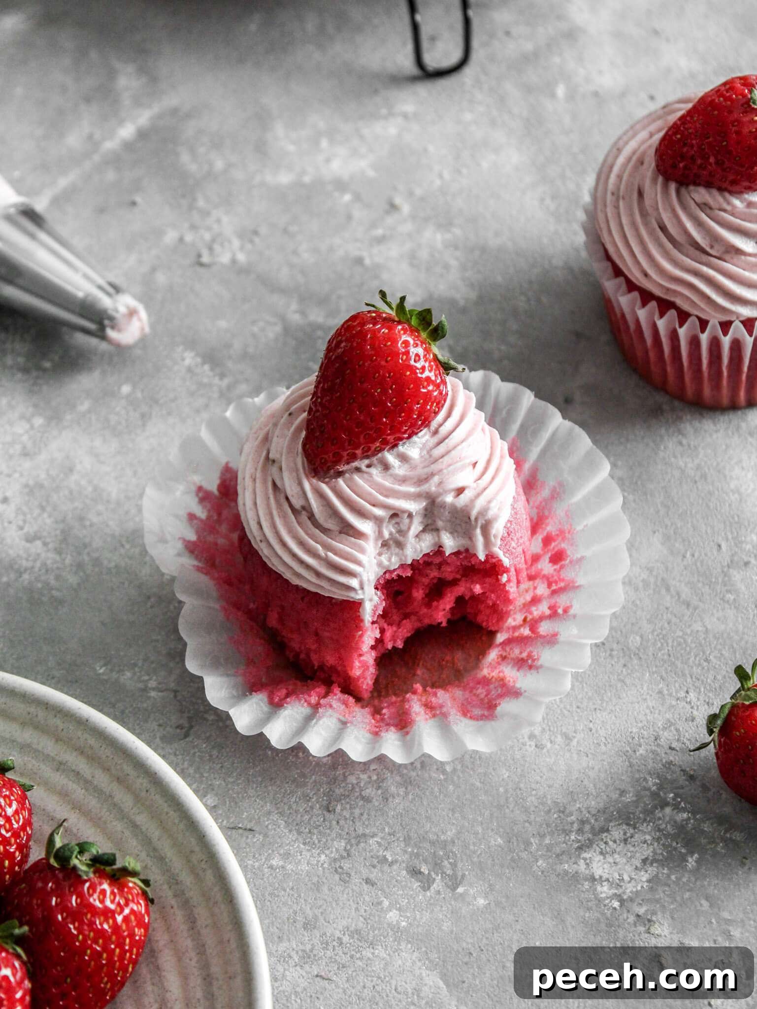 Fluffy Strawberry Cupcakes with Fresh Strawberry Frosting 3 frosted strawberry cupcake on table (1)