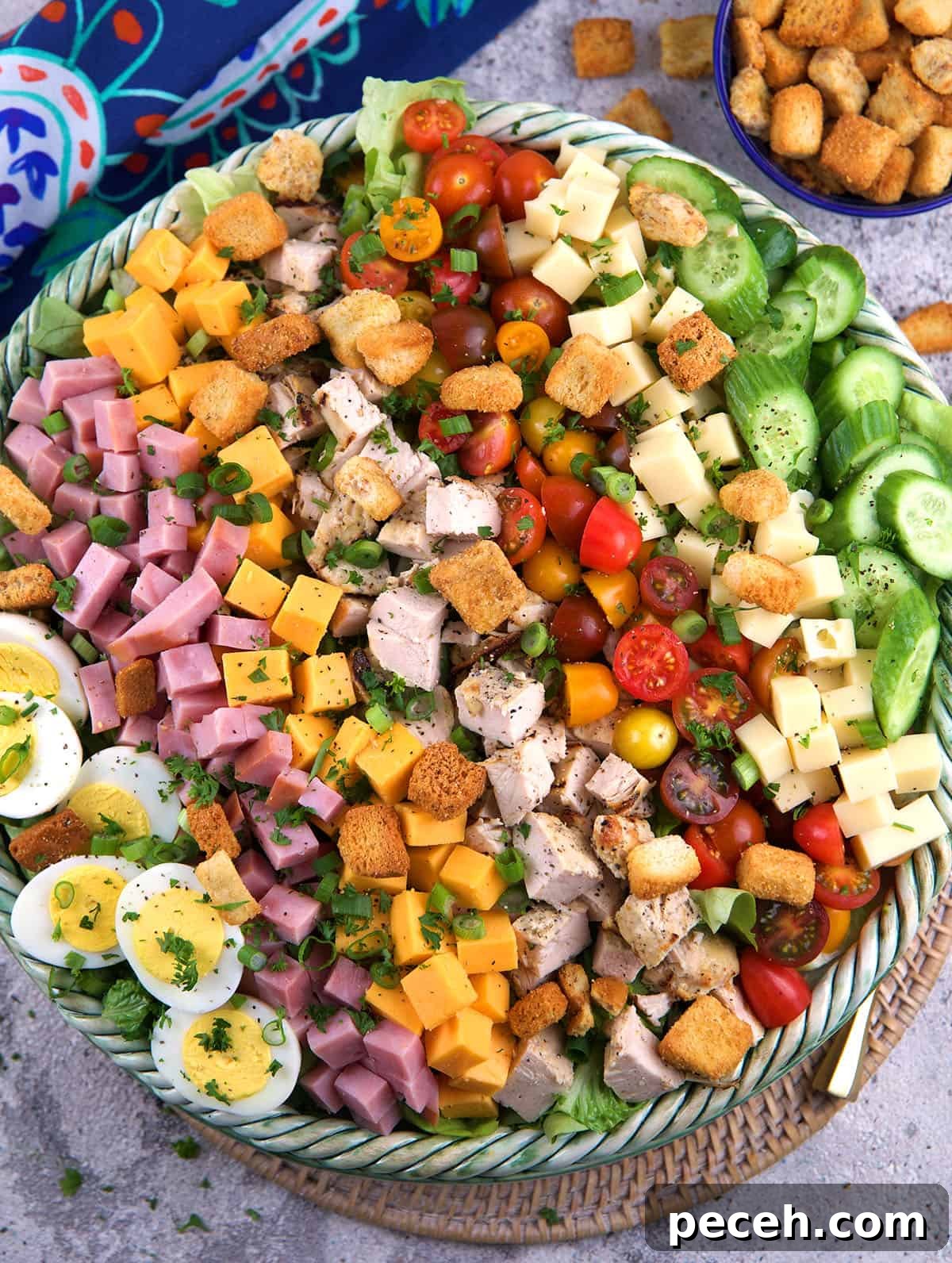 Leftover Ham Recipes: Tasty Ideas for Simple Meals 11 A large bowl filled with chefs salad is placed on a tabletop.