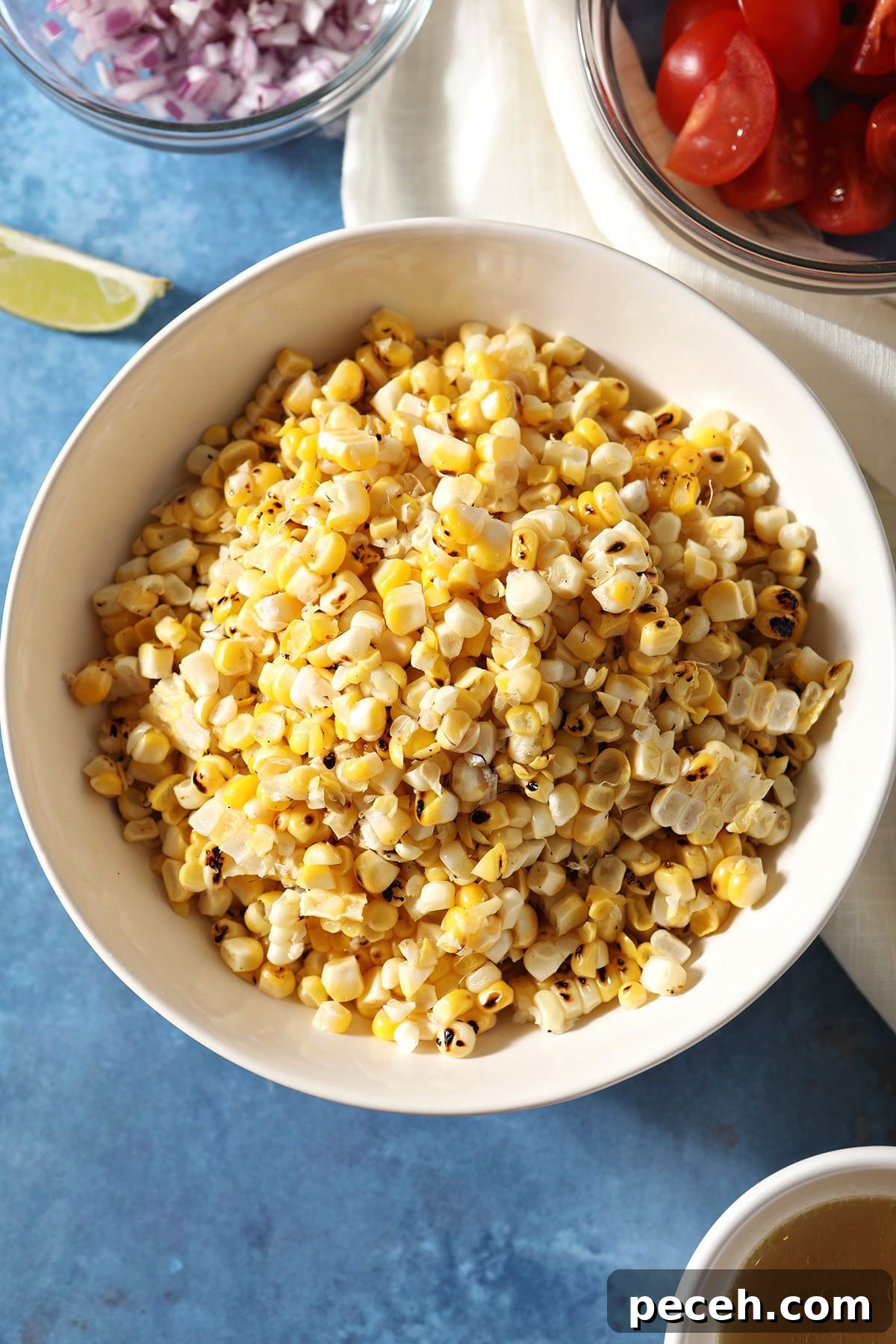 Smoky Charred Corn Salsa with Cilantro and Lime 5 Charred corn in a bowl surrounded by other ingredients