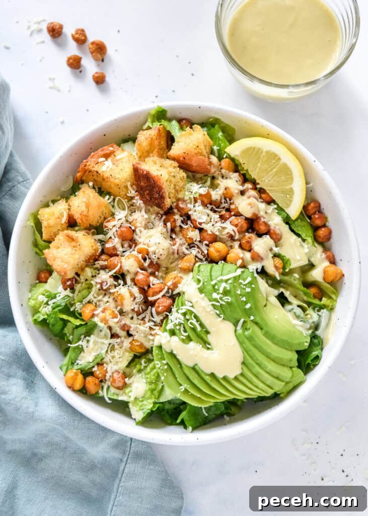 Crispy Roasted Chickpea Caesar Salad 9 roasted chickpea caesar salad with avocado and croutons in a white bowl.