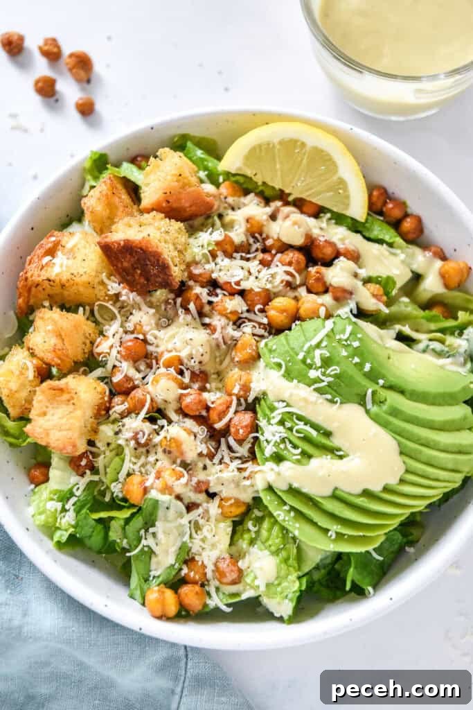Crispy Roasted Chickpea Caesar Salad 13 roasted chickpea caesar salad with avocado and croutons in a white bowl.