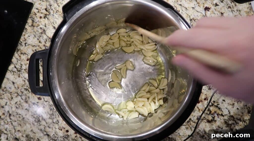 Creamy Garlic Chicken Pasta in the Instant Pot 13 Adding garlic to pot
