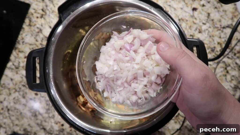 Creamy Garlic Chicken Pasta in the Instant Pot 15 Adding shallots to pot