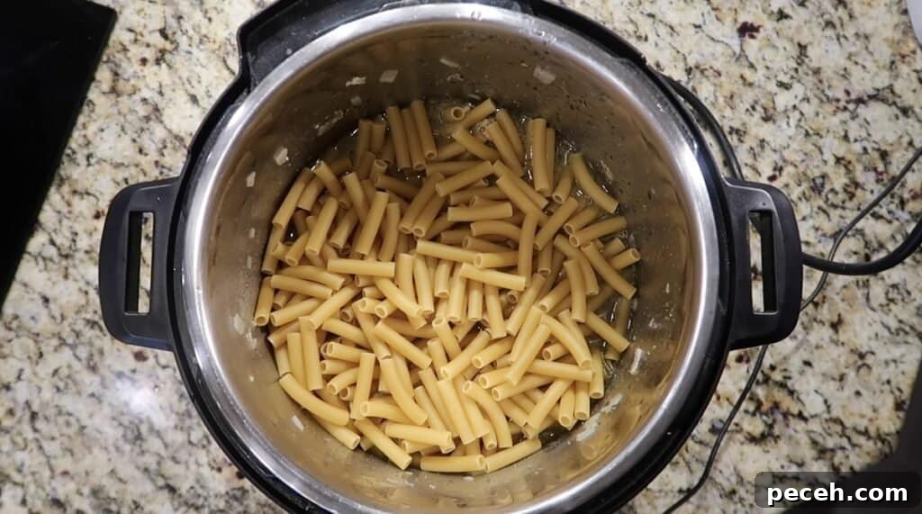 Creamy Garlic Chicken Pasta in the Instant Pot 18 Adding ziti to pot