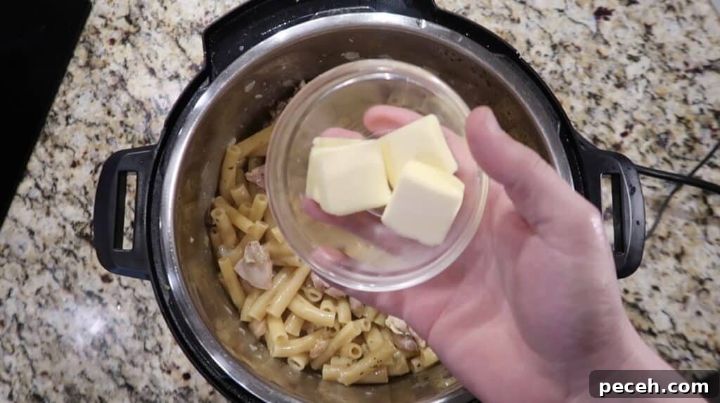 Creamy Garlic Chicken Pasta in the Instant Pot 20 Adding butter to pot
