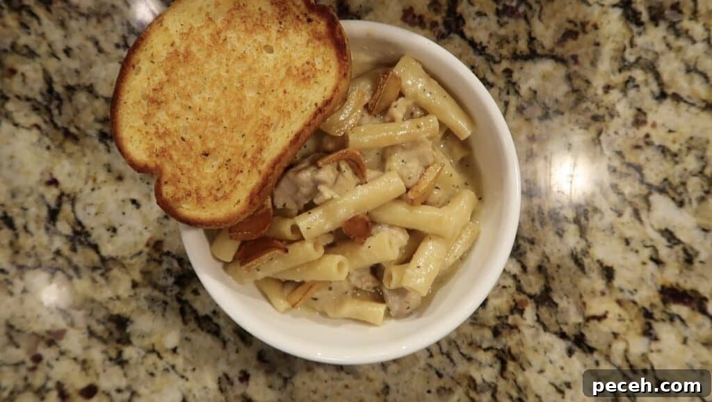 Creamy Garlic Chicken Pasta in the Instant Pot 25 Adding garlic bread to pasta